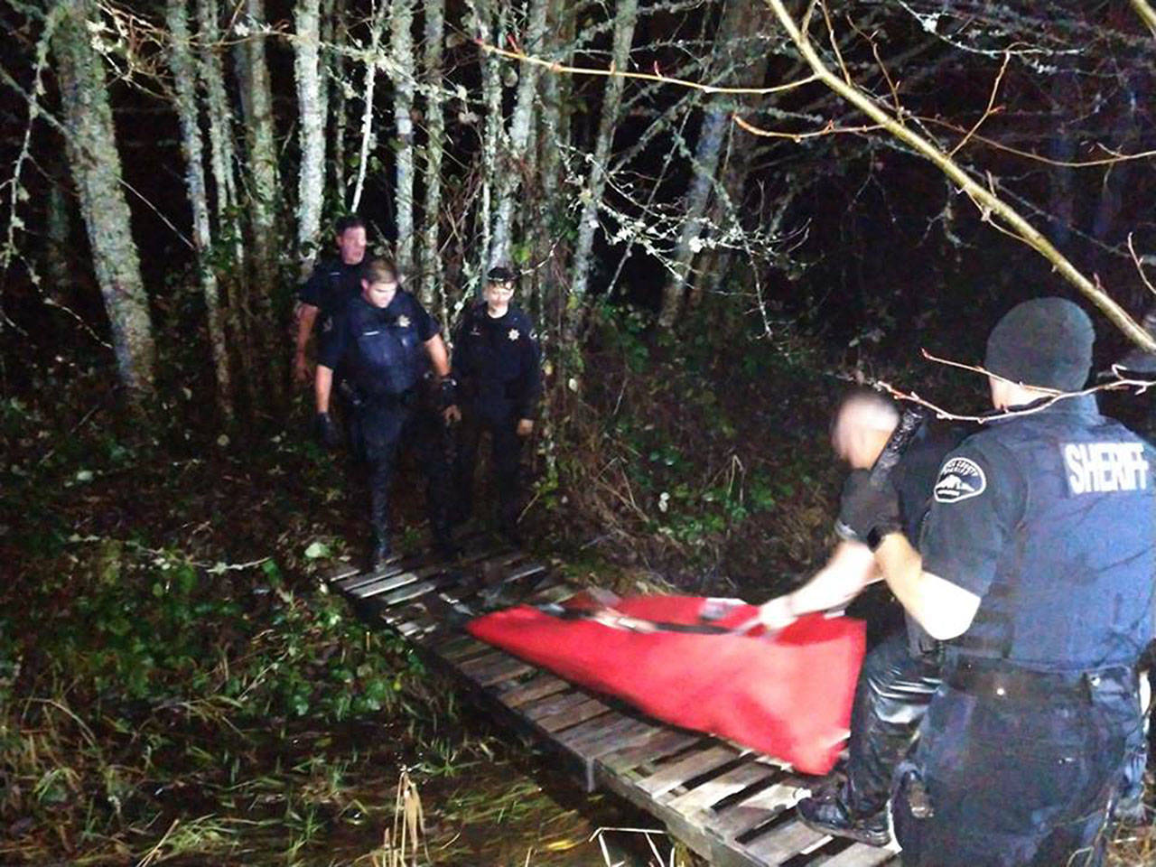 Deputies used a body bag to help carry the unresponsive suspect out of the swamp near Orting. They also had to use a ladder and some pallets to construct a rescue bridge over a creek and out of the swamp. Photo courtesy Pierce County Sheriff’s Department