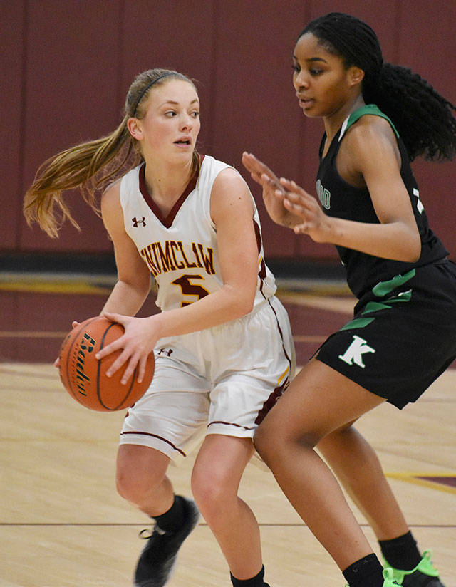 The Enumclaw High. After the two-day tournament holiday tournament, the Hornets hosted Kentwood the afternoon of Dec. 29. Things went the way of the visitors, who left Chuck Smith Gymnasium on the winning side of a 59-48 score. Left, Enumclaw’s Rebecca Lindberg looks for an open teammate. Photo by Kevin Hanson