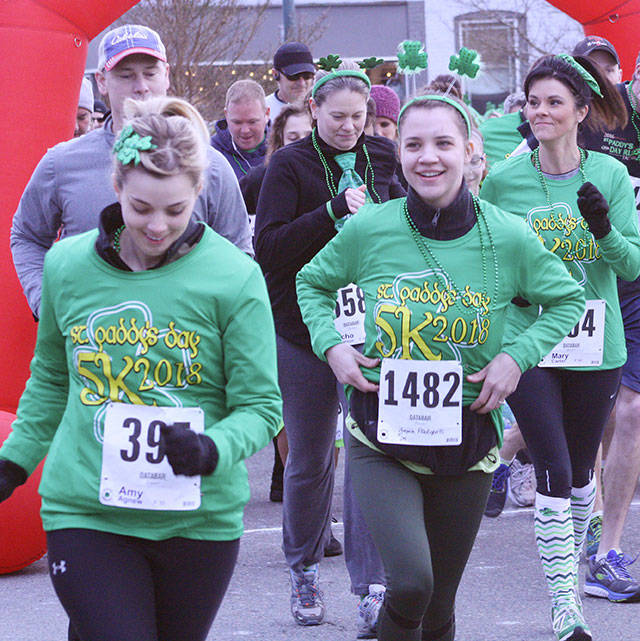 Runners bolt from the starting line during last year’s St. Paddy’s 5K. File photo by Kevin Hanson