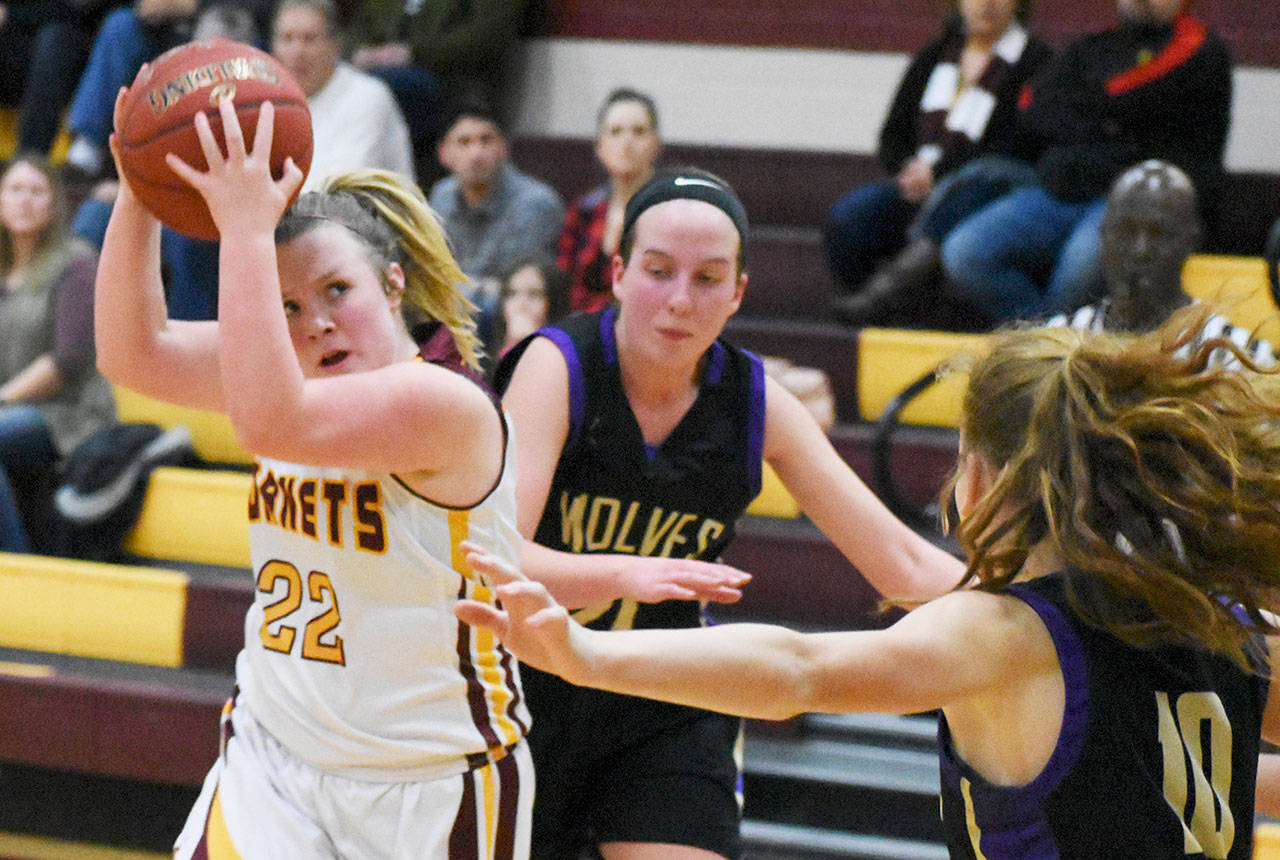 White River freshman Sydney Lund pulls down a rebound during a district playoff game against Sequim. The home-court victory moved the Hornets closer to the state tournament. White River began state play Thursday. File photo by Kevin Hanson