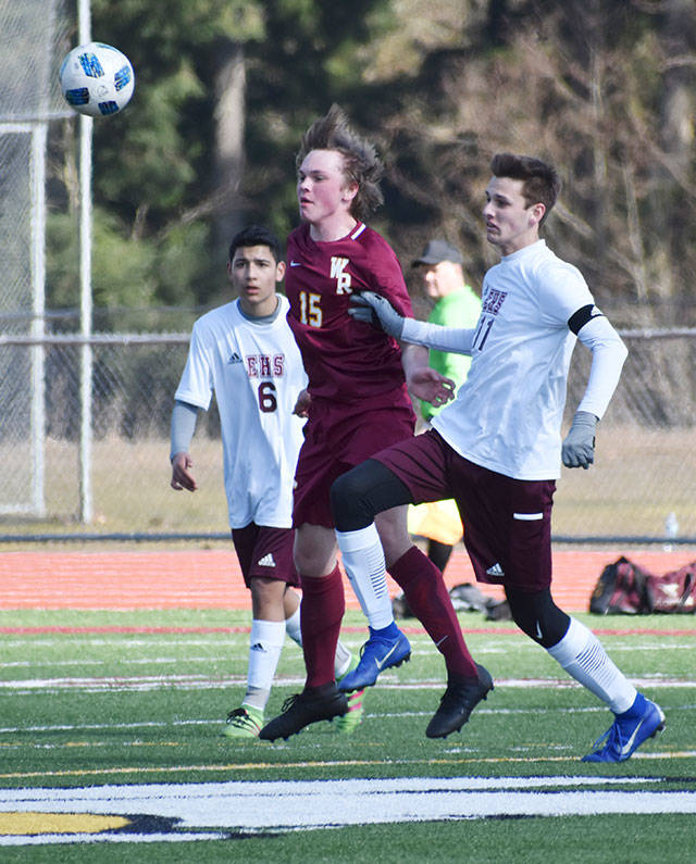The Hornet-Hornet battle between neighboring White River and Enumclaw was played to a sunny, scoreless draw Saturday afternoon at Arrow Lumber Stadium. Pictured is White River’s Austin Rogers as he chases a loose ball between Enumclaw’s Eluar Gutierrez (6) and Kyle Revell (11). Photo by Kevin Hanson