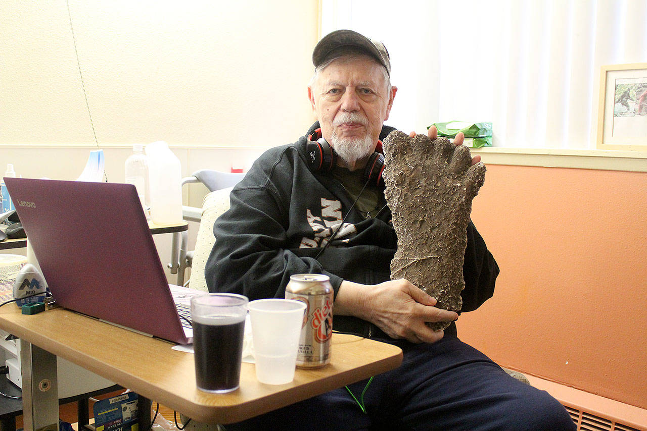 Thom Cantrell, one of the organizers of the upcoming International Conference for Primal People, holds up a mould of a Sasquatch footprint. He said the mould was taken in the Blue Mountains in Oregon by Paul Freeman, a well-known Sasquatch hunter who’s 1994 footage of a Sasquatch in that area made big waves in the believer and skeptic communities alike. Photo by Ray Miller-Still