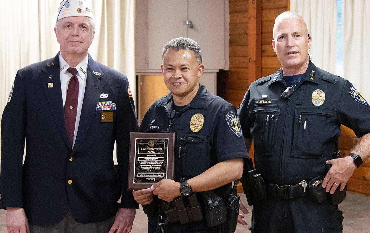 Police Officer Kim-Xuan Brewer, above, was presented an award by VFW Post Commander Tom Krueger and Police Chief Bob Huebler. Also honored were Enumclaw firefighters Capt. John Bloomer and Alex Lind, below. Photos provided by VFW Post 1949