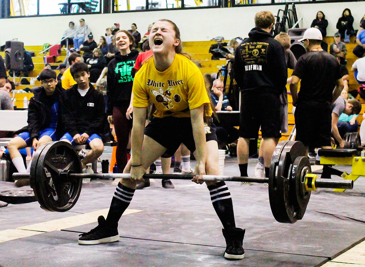 On her way to a third-place finish is Emily Nelson, shown here dead lifting 270 pounds. Below, Konor McCoy, also a third-place finisher, dead lifts 450 pounds. Photo courtesy Ella Moyer