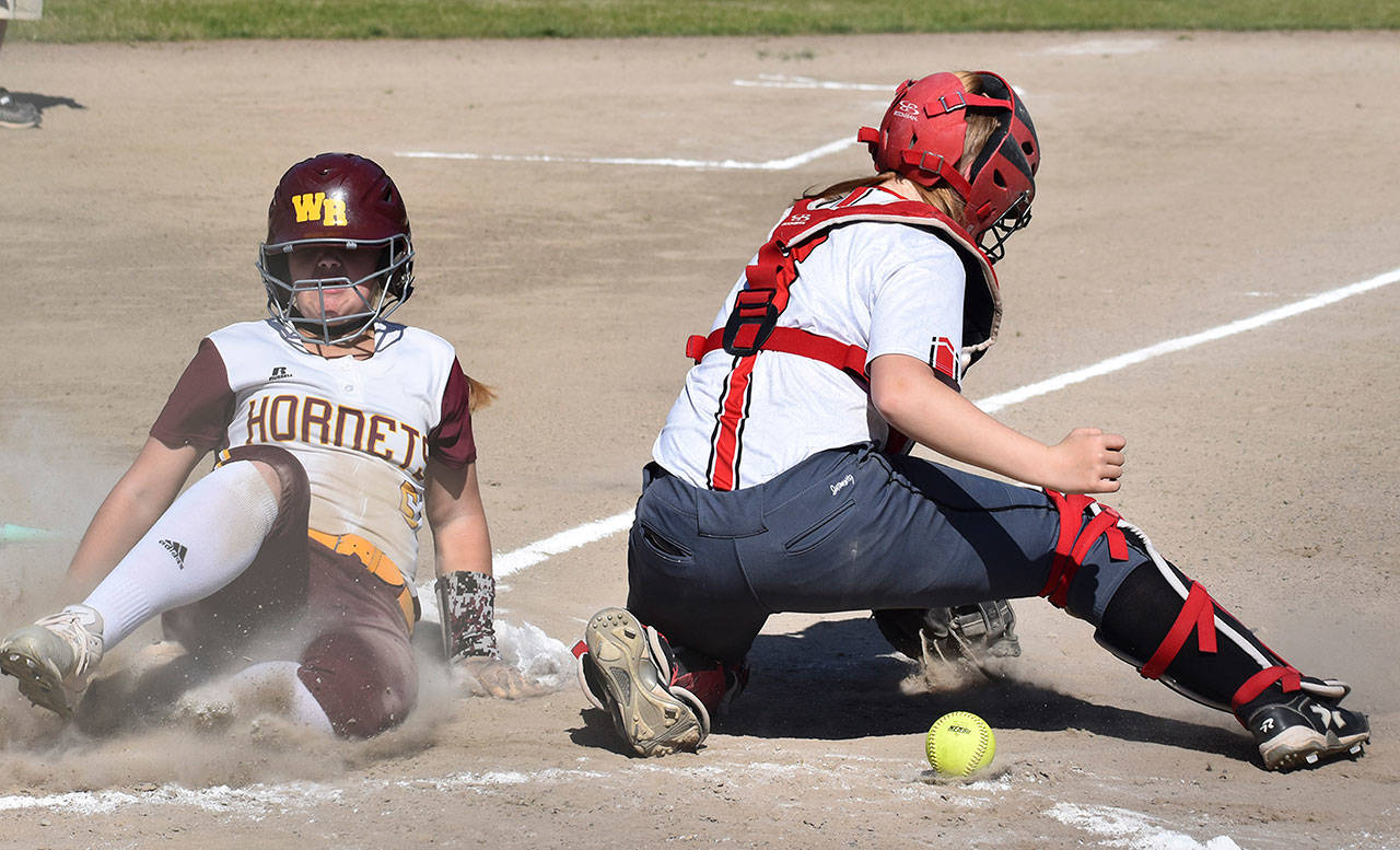The White River girls advanced in the South Puget Sound League 2A softball tournament May 8 with a 6-4 victory over the Orting Cardinals. Above, Marissa Dolson slides safely into hone during a three-run inning. Photo by Kevin Hanson
