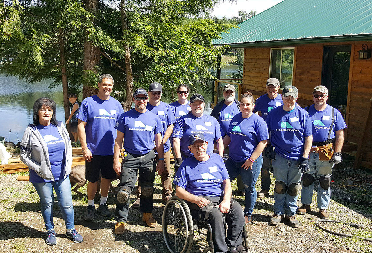 Work crews converged on the home of Black Diamond resident Terry Hildebrand during this year’s Rampathon event. Below, volunteers assemble the ramp before gathering for a group photo with Hildebrand. Contributed photos