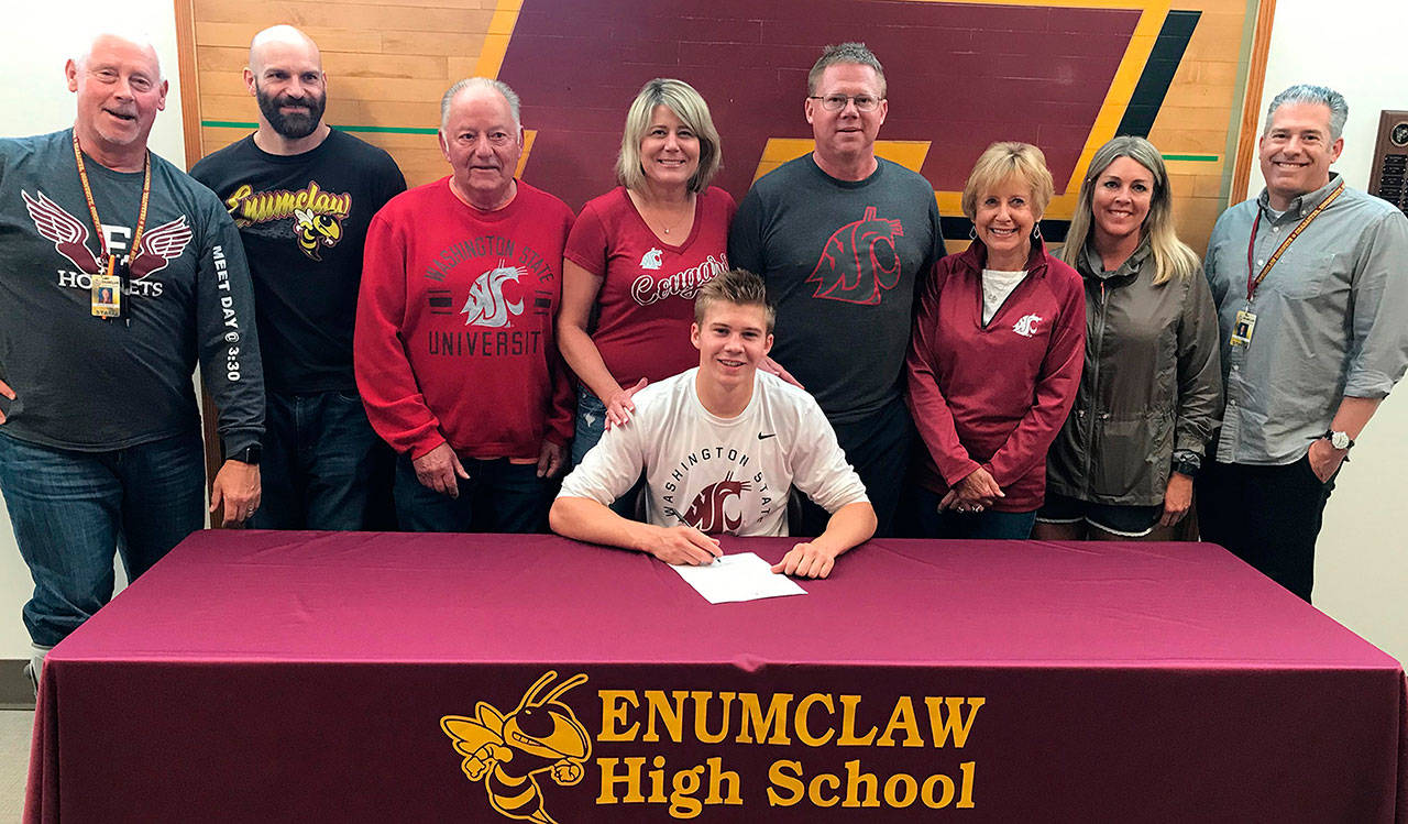 Enumclaw High’s Carson Christiansen was surrounded by family, friends, and coaches May 31 when he signed an athletic letter-of-intent with Washington State University. The Hornet senior is coming off a track and field season that saw him shine at he state championships. Competing in the Class 4A field in Tacoma, the incoming Cougar placed second in the long jump and fourth in the triple jump. Photo courtesy Enumclaw High athletics.