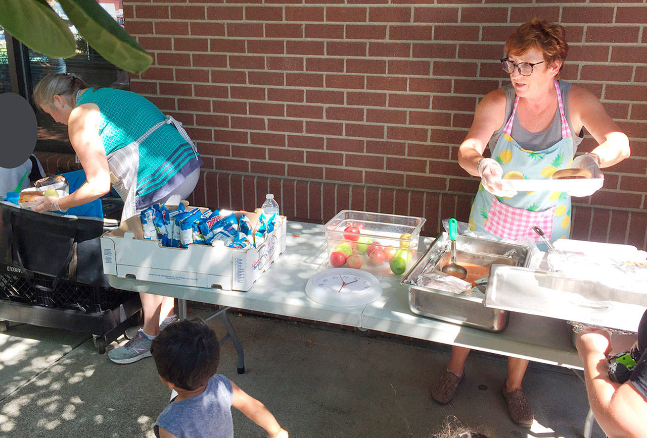 Summer Food Program workers prepare to serve from a site at the Enumclaw library. This photo was from summer 2018, but the program and site remain the same. Photo courtesy Enumclaw School District.