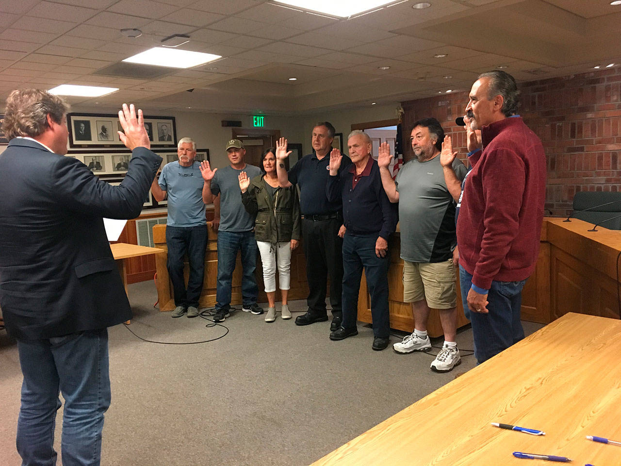 King County Council member Reagan Dunn swearing in new Commissioners from Drainage Districts 5, 6 and 13. L-R: Reagan Dunn, John Koopman, Kenny Bosnik, Cathy Dahlquist, Alan Predmore, Jim Puttman, John Millarich, Mark Van Wiernigan, and David Ballestrasse. Contributed by David Shurtleff