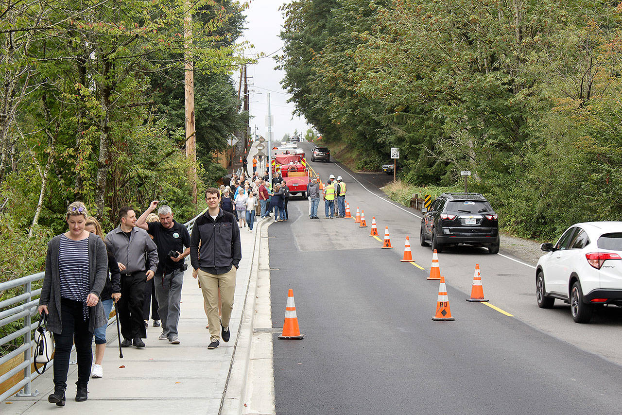 The City of Black Diamond came out Aug. 22 to celebrate the official opening of the pedestrian bridge that passes over the Rock Creek on Roberts Drive. In order to make sure pedestrians and city officials could safely perform the ribbon cutting and have photos taken, the Black Diamond Police Department and Mountain View Fire and Rescue (with Black Diamond’s historical fire engine) blocked off the street for a few minutes. Photo by Ray Miller-Still