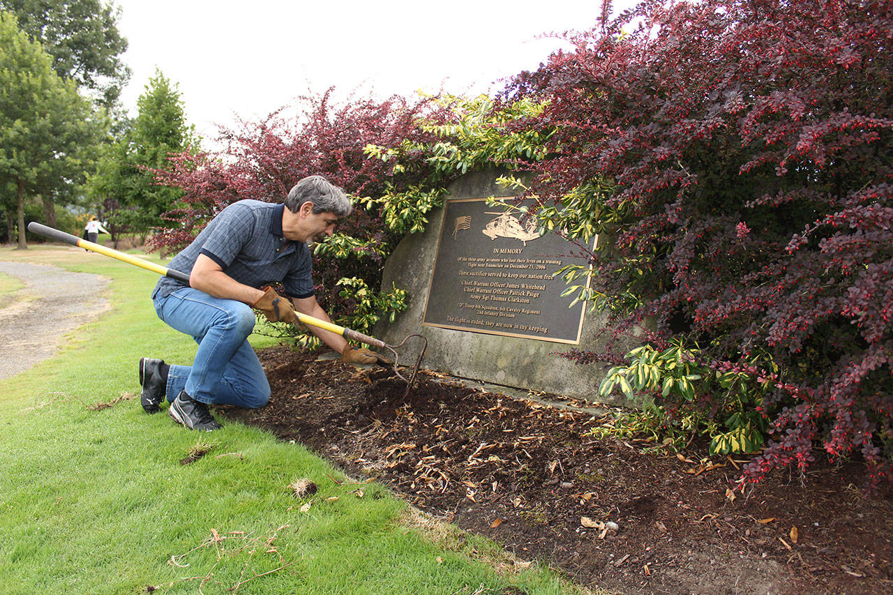 Enumclaw Mayor Jan Molinaro cleans up at his city’s Veterans Memorial Park during last year’s Beautify event. Photo by Ray Miller-Still