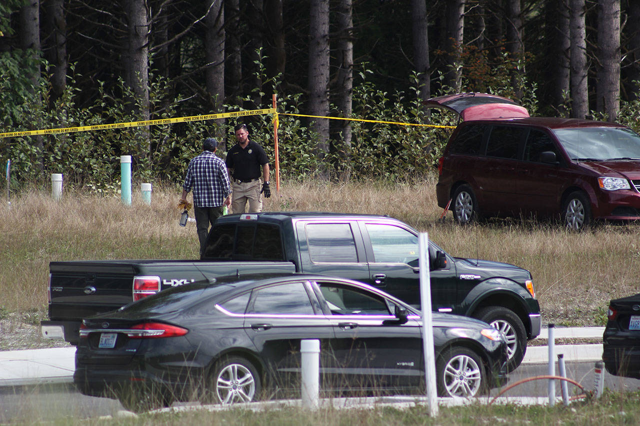 King County Sheriff Department deputies searching the woods behind the Ten Trails housing development in Black Diamond for additional human remains. Photo by Ray Miller-Still
