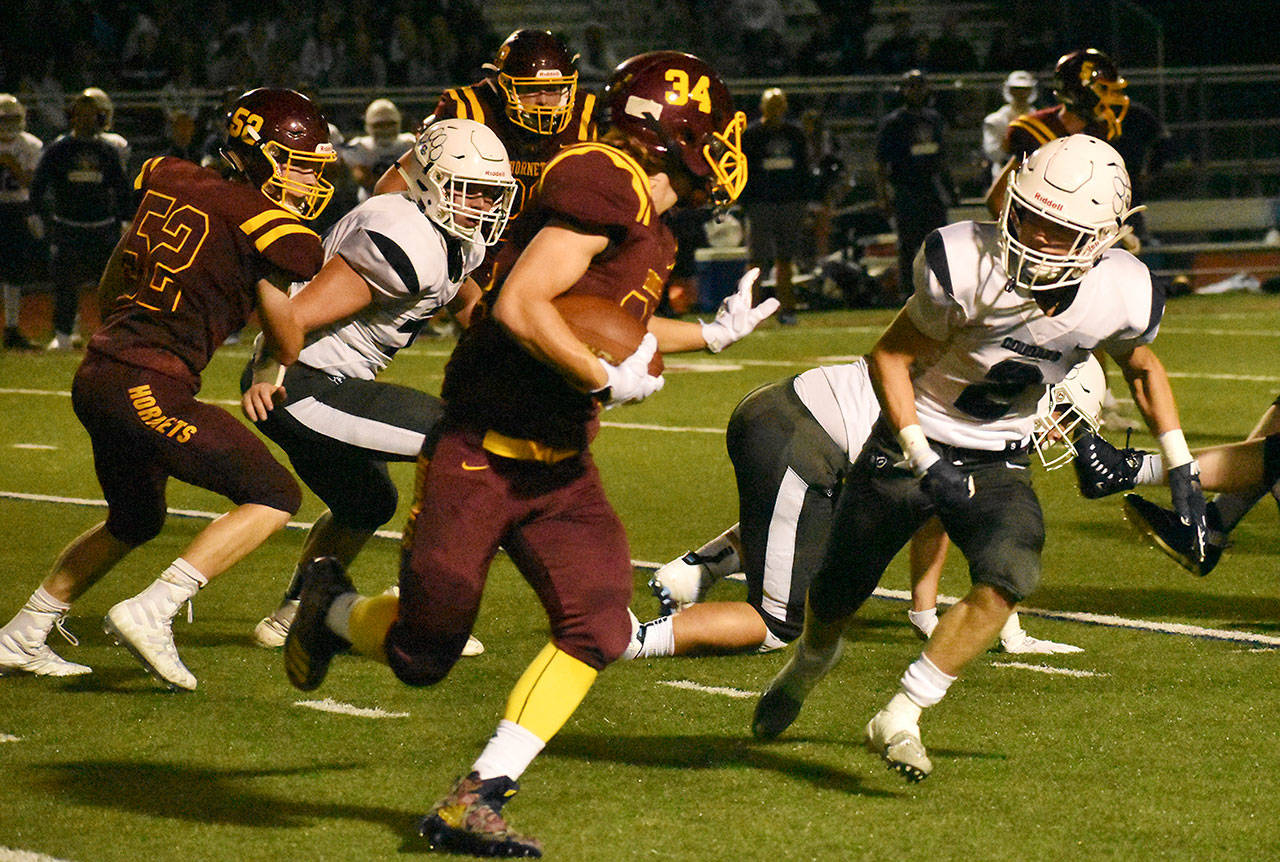 White River High’s Payne Plaster scoots outside the Cascade Christian defense for a late touchdown that gave the Hornets a short-lived lead. The visiting Cougars responded with a game-winning drive and sealed the victory in the game’s final minute. Photo by Kevin Hanson