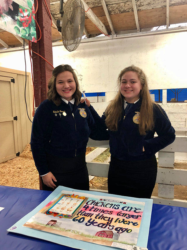 White River High School student Natalie Gomez, left, with her sister Alexandra at this year’s Washington State Fair, representing their school’s FFA Chapter, which Natalie is president of. Contributed photo.