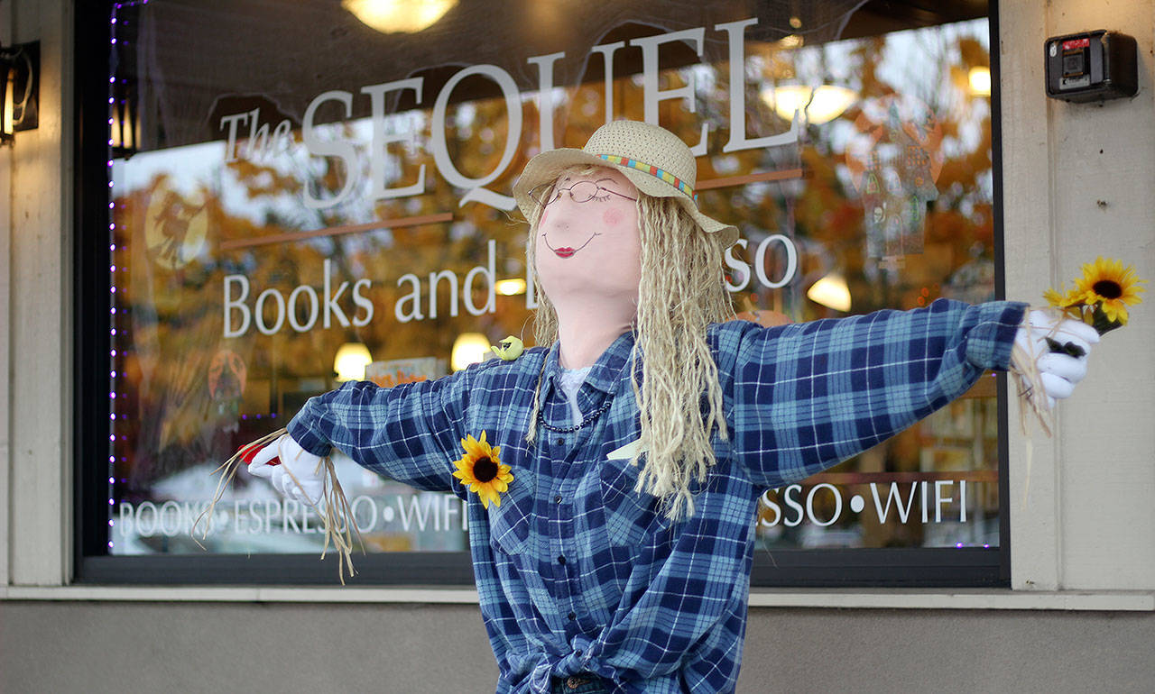 Though the rain appeared to wash out Enumclaw’s first-ever Scarecrow Festival on Oct. 19, businesses like The Sequel still had their scarecrows out for display in front of their stores or behind glass. Photo by Ray Miller-Still