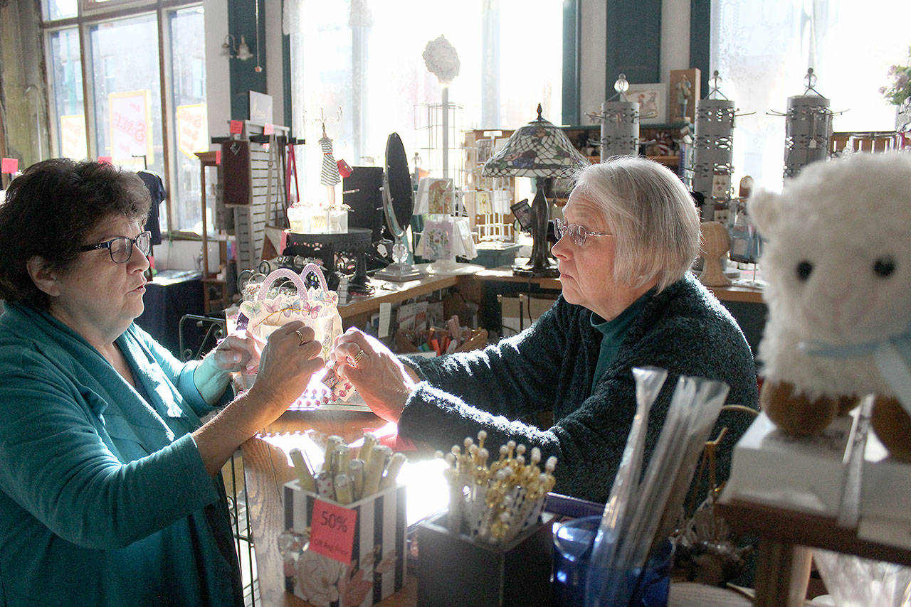 Peggy Wenham and one of her customers started reminiscing about Enumclaws past as Wenham rung her items up. Photo by Ray Miller-Still