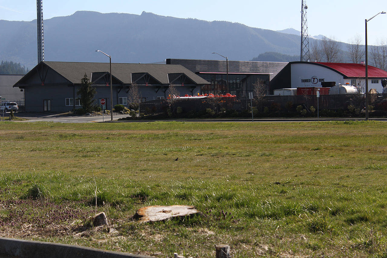 The Thunder Dome car museum is looking to build a commercial building on this lot, which is located right next to the Enumclaw library and the communal garden. Photo by Ray Miller-Still