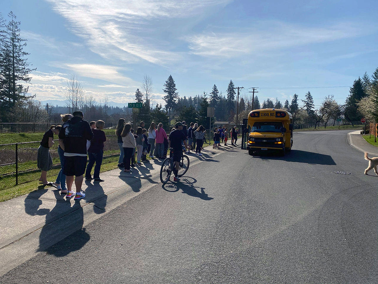 A handful of White River School District families lined up in front of a school bus to pick up sack breakfasts and lunches for their children back in March, when the pandemic began. Photo courtesy White River School District