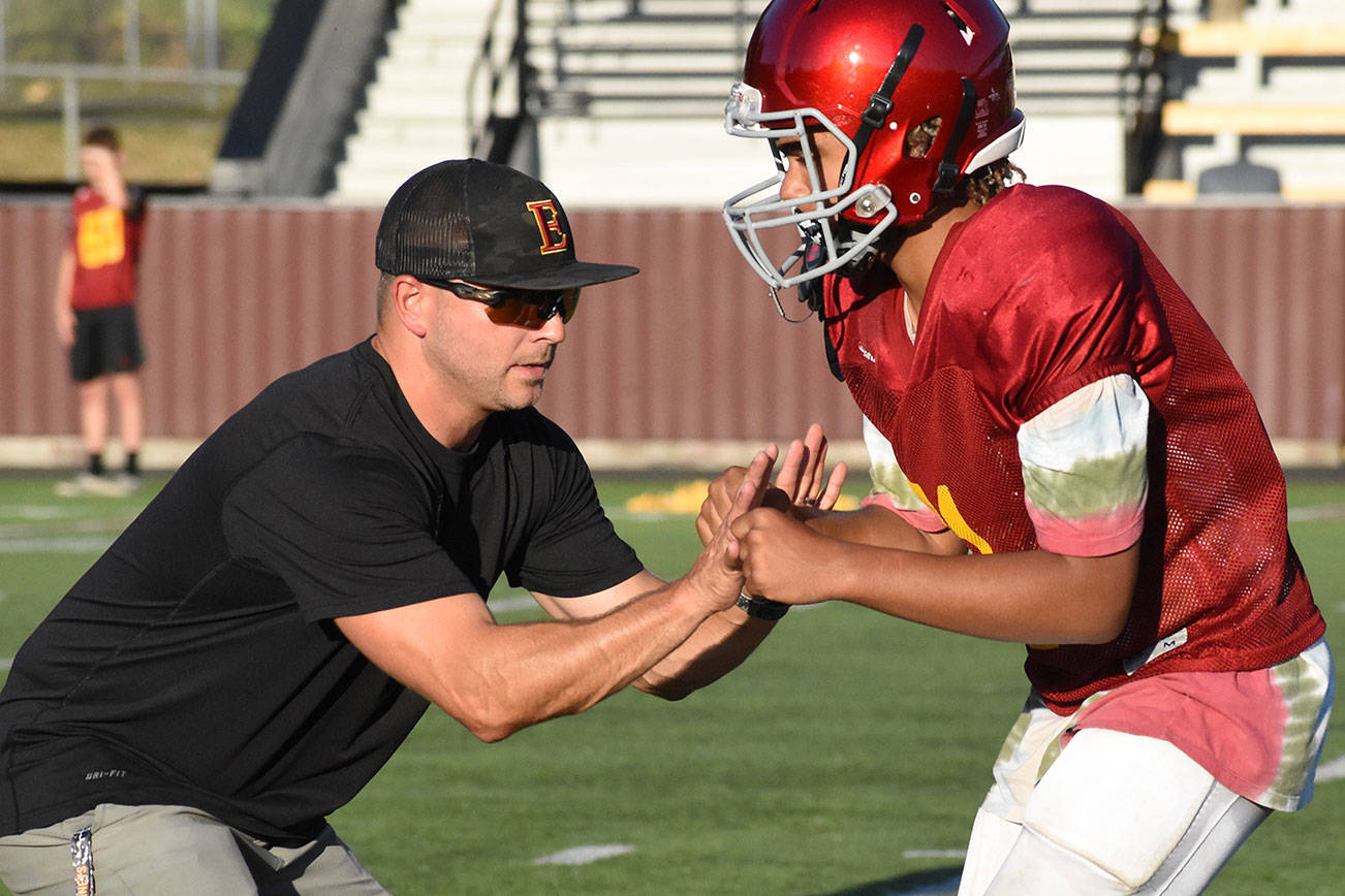 It's been a while since local schools have been able to practice sports. Pictured is Coach Mark Gunderson working on technique with one of his players during an Aug. 28, 2019 practice. Photo by Kevin Hanson