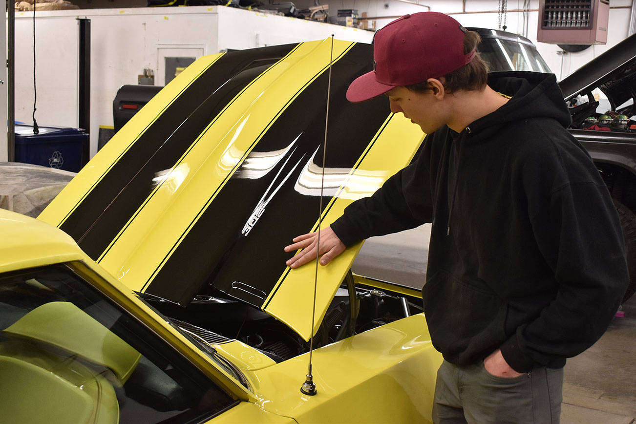 Josh Sanders, owner of Sanders' Street Rods, points out details in a 1969 Z28 Camaro currently being worked on at the shop in Enumclaw on March 5. Photo by Alex Bruell