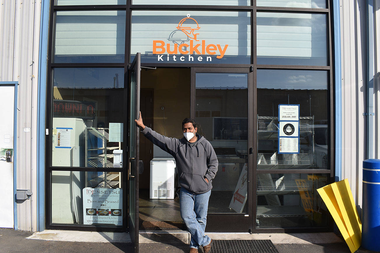 Teago Manoharan on March 16 holds open the door to the Buckley Kitchen, a commissary kitchen he started in 2019 that hosts a number of bakers and chefs who couldn't otherwise afford a space to cook. Photo by Alex Bruell