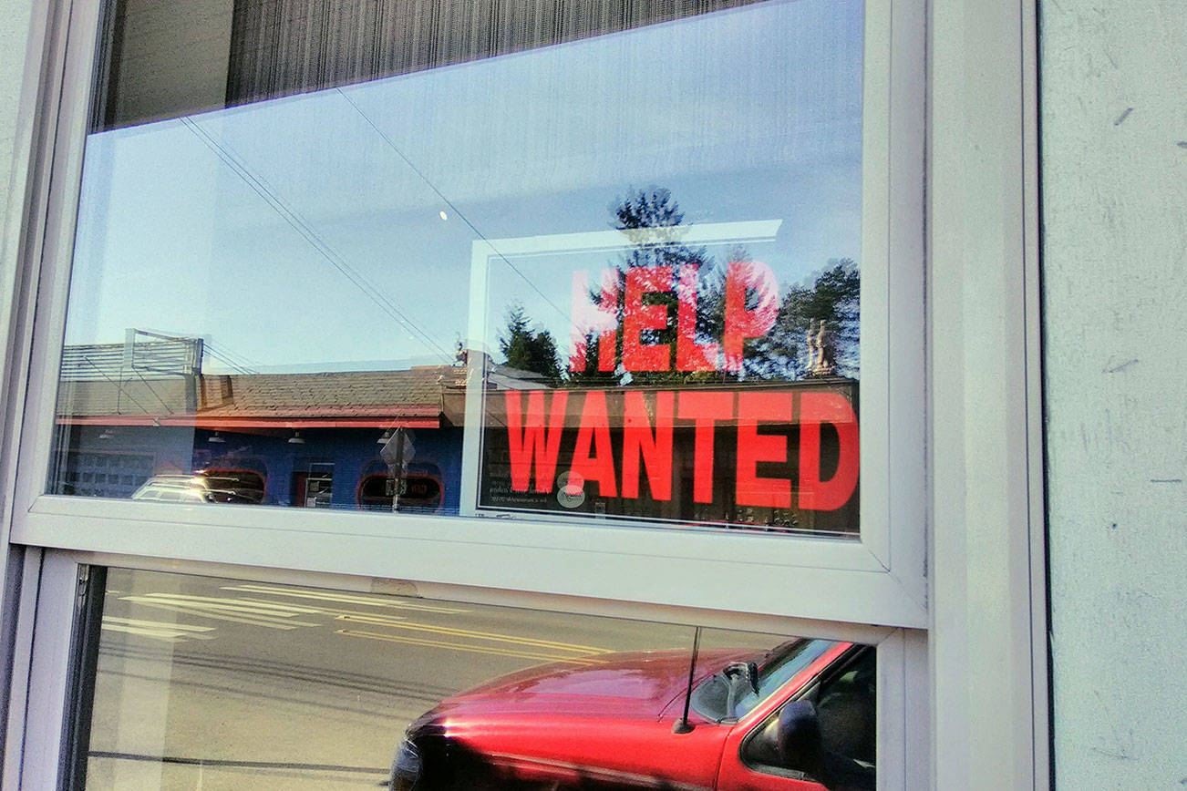 Help wanted sign in the window. File photo