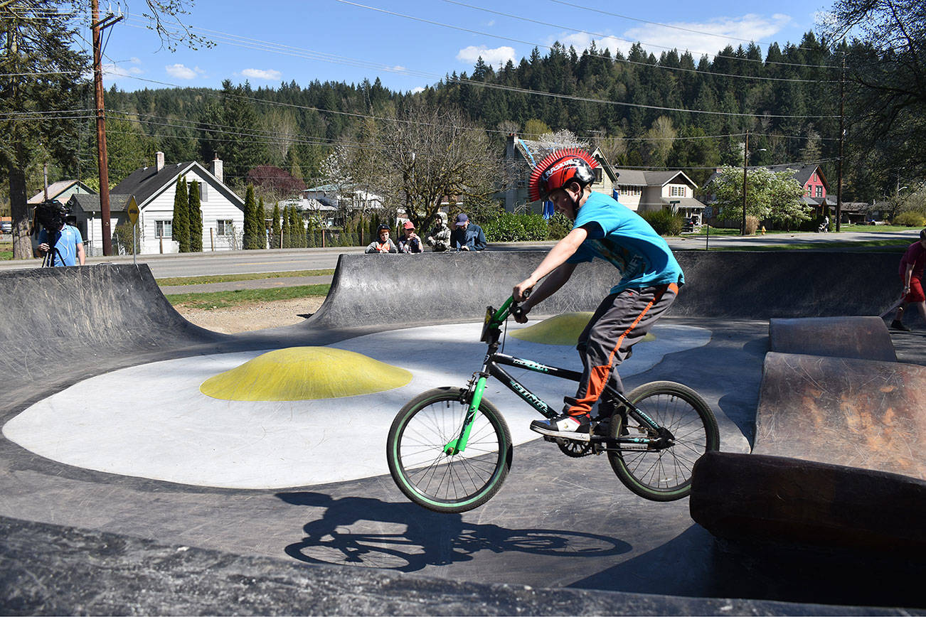 10-year-old Micah Sharp, a Wilkeson boy, rides his bike off of a giant piece of bacon at the new Bacon and Eggs skatepark in Wilkeson on Carbonado South Prairie Road the afternoon of April 20. Photo by Alex Bruell