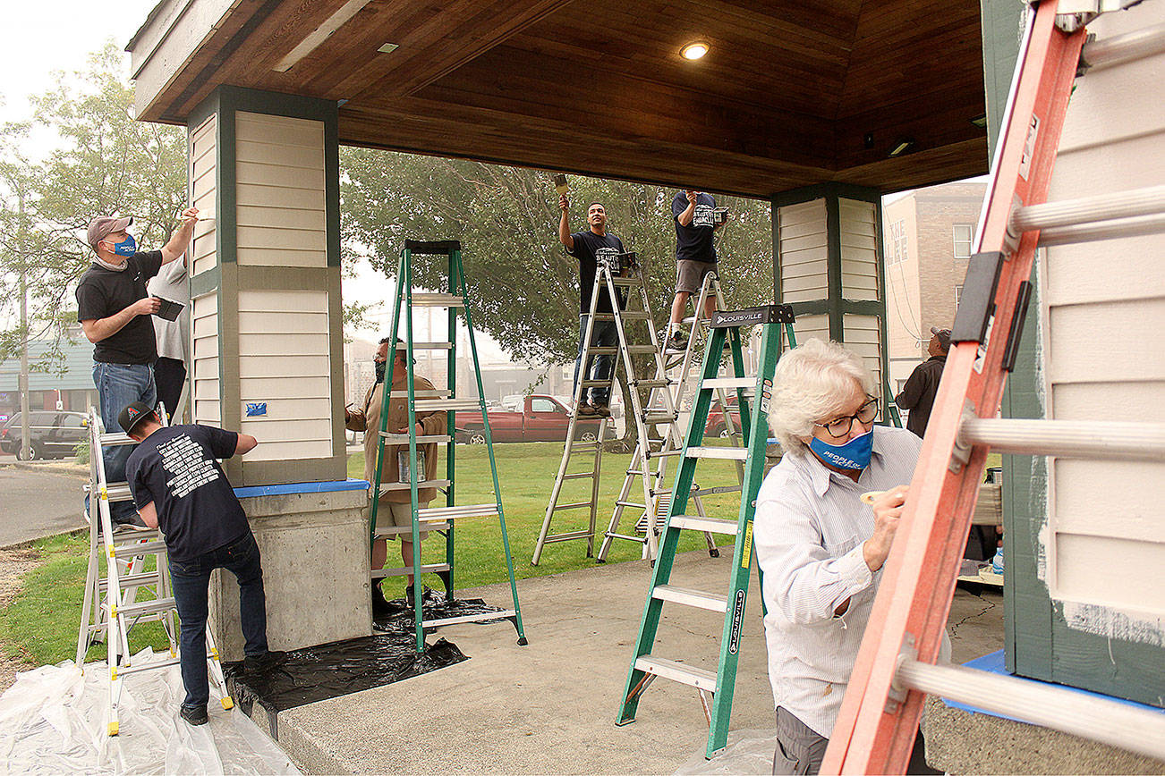 Despite bad air quality last year, more than 60 volunteers donned their masks and got to work making Enumclaw a more beautiful place to live, including repainting the Rotary Park gazebo. Photo by Ray Miller-Still