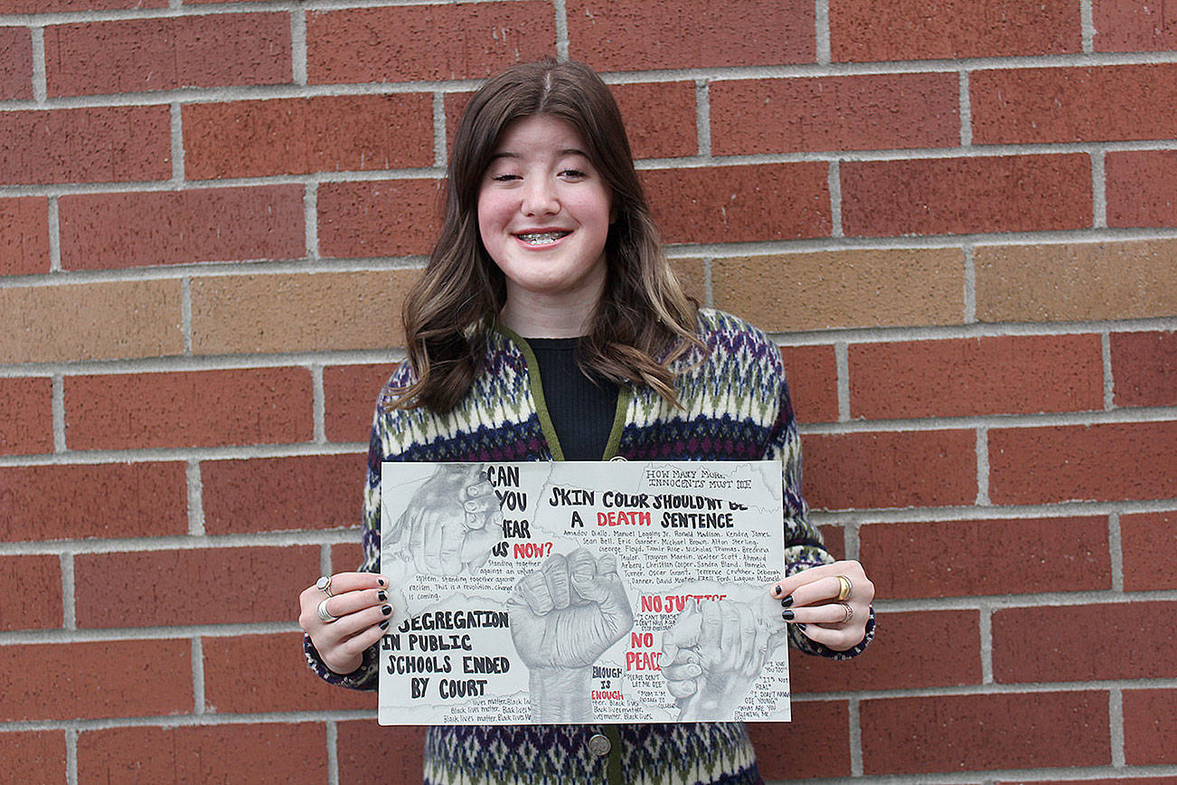 Enumclaw High senior Meredth Petellin with her award-winning piece of art, "Liberty and Justice." Photo by Ray Miller-Still