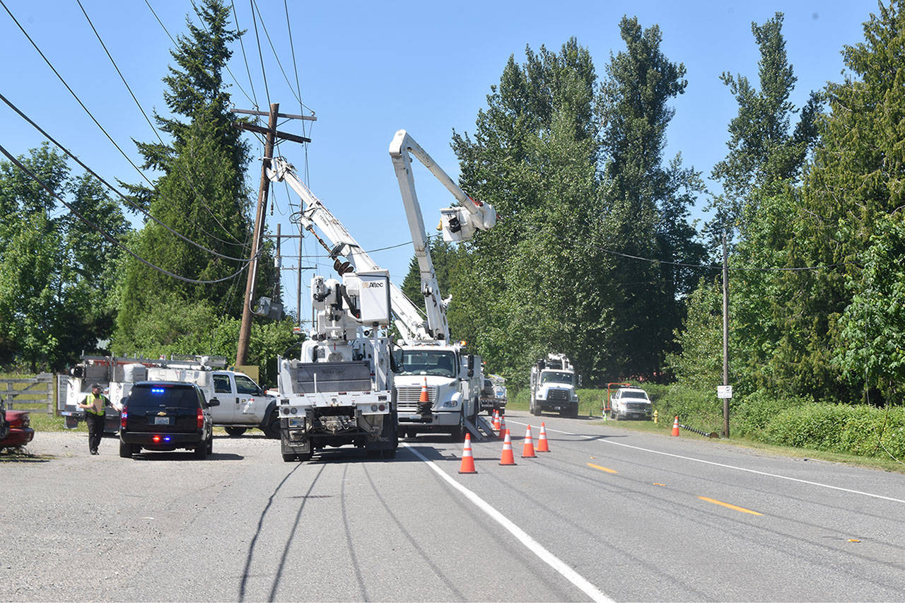 Crews work on repairs on Highway 169 in Black Diamond, where a motorist struck a power pole earlier that morning. Photo by Alex Bruell