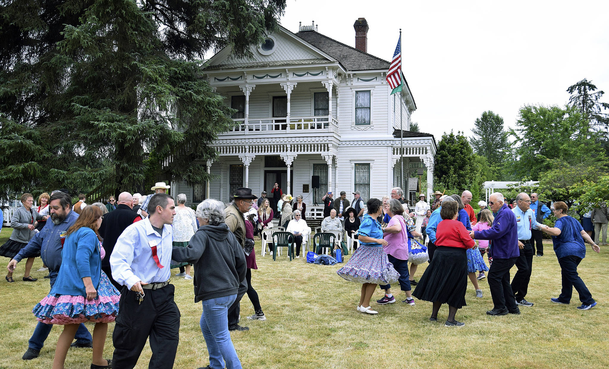 People square dancing in front of the Neely Mansion