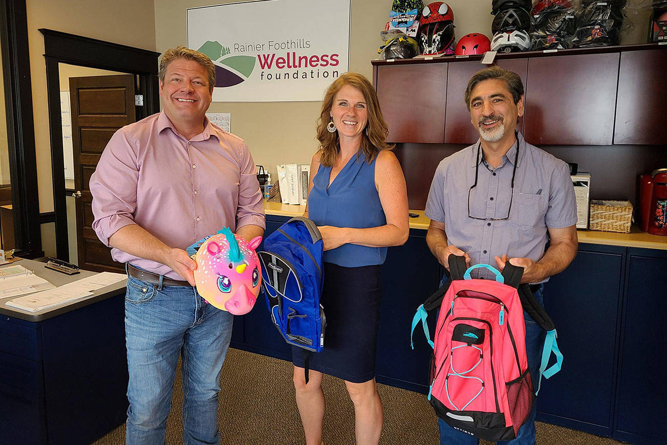 Metropolitan King County council member Reagan Dunn, Rainier Foothills Wellness Foundation Executive Director Sara Stratton and Enumclaw Mayor Jan Molinaro pose for a picture at the Foundations Enumclaw office. Photo provided by Dunns staff.