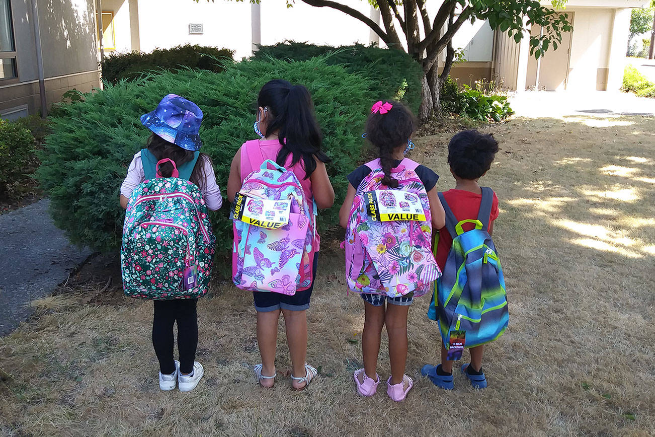 Photo provided by Y Center Office Manager Christine Adkins 
A group of kids shows off backpacks from the Y Social Impact Center’s school supplies drive.