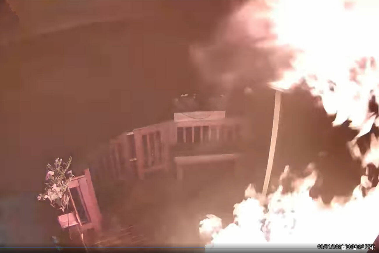This image, taken from a video shared by the King County Sheriff’s Office, shows the conflagration started by an unknown person on the porch of an Enumclaw household. A link to the video is included in the article.