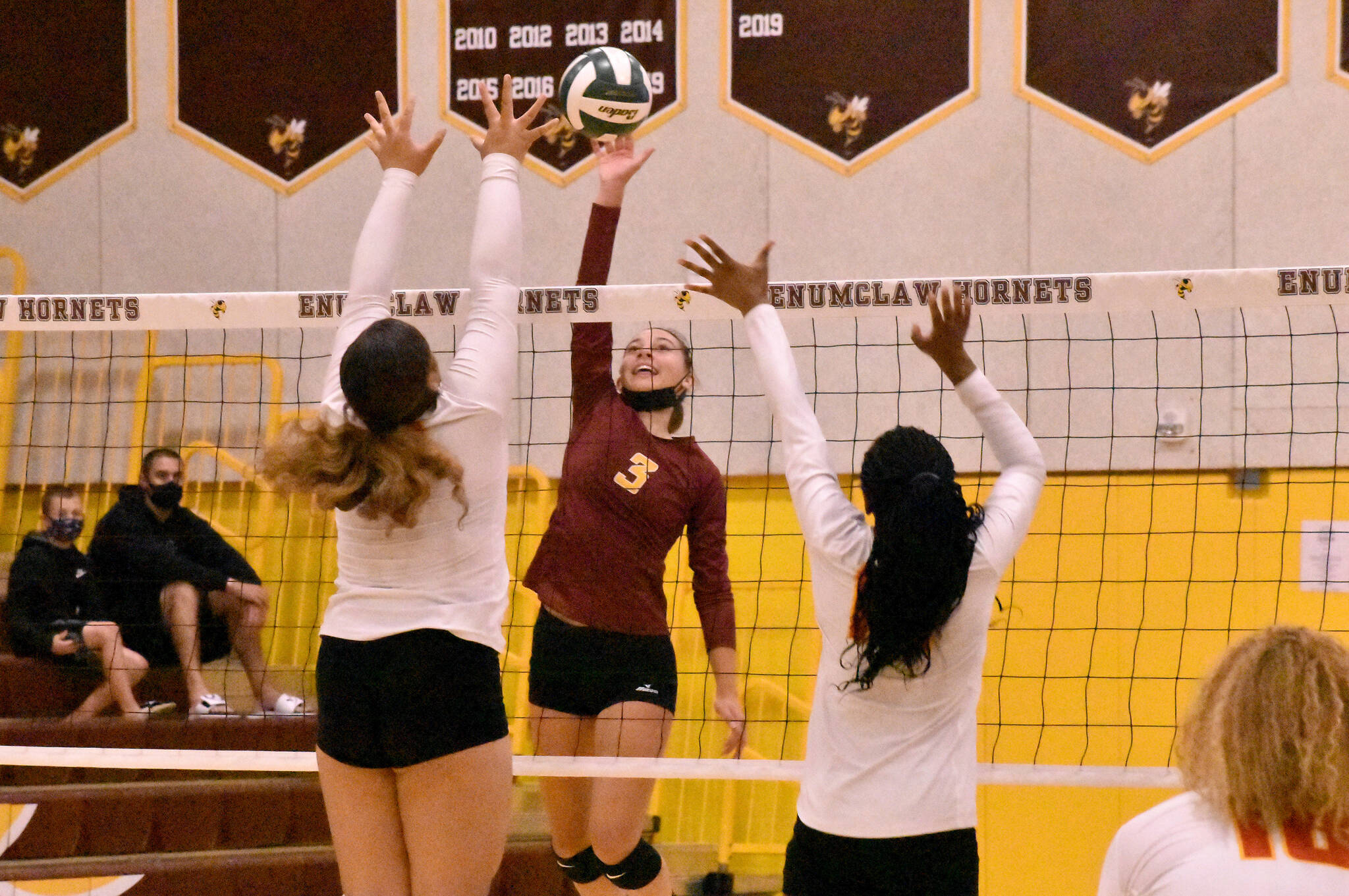Samantha Darby (#3) goes high for a kill. Photo by Kevin Hanson.