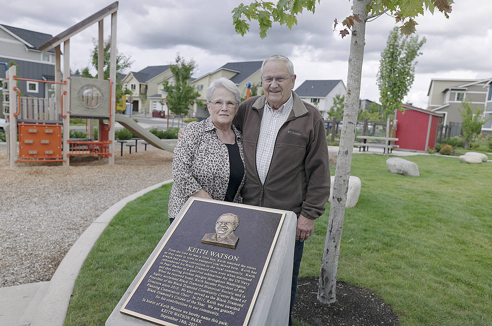 Courtesy photo 
Keith Watson and his wife Judy at the newly-renamed Keith Watson Park, located at the intersection of SE Cottonwood Street and Birch Ave SE. The plaque at the park gives a short history of Watson’s involvement in Black Diamond.