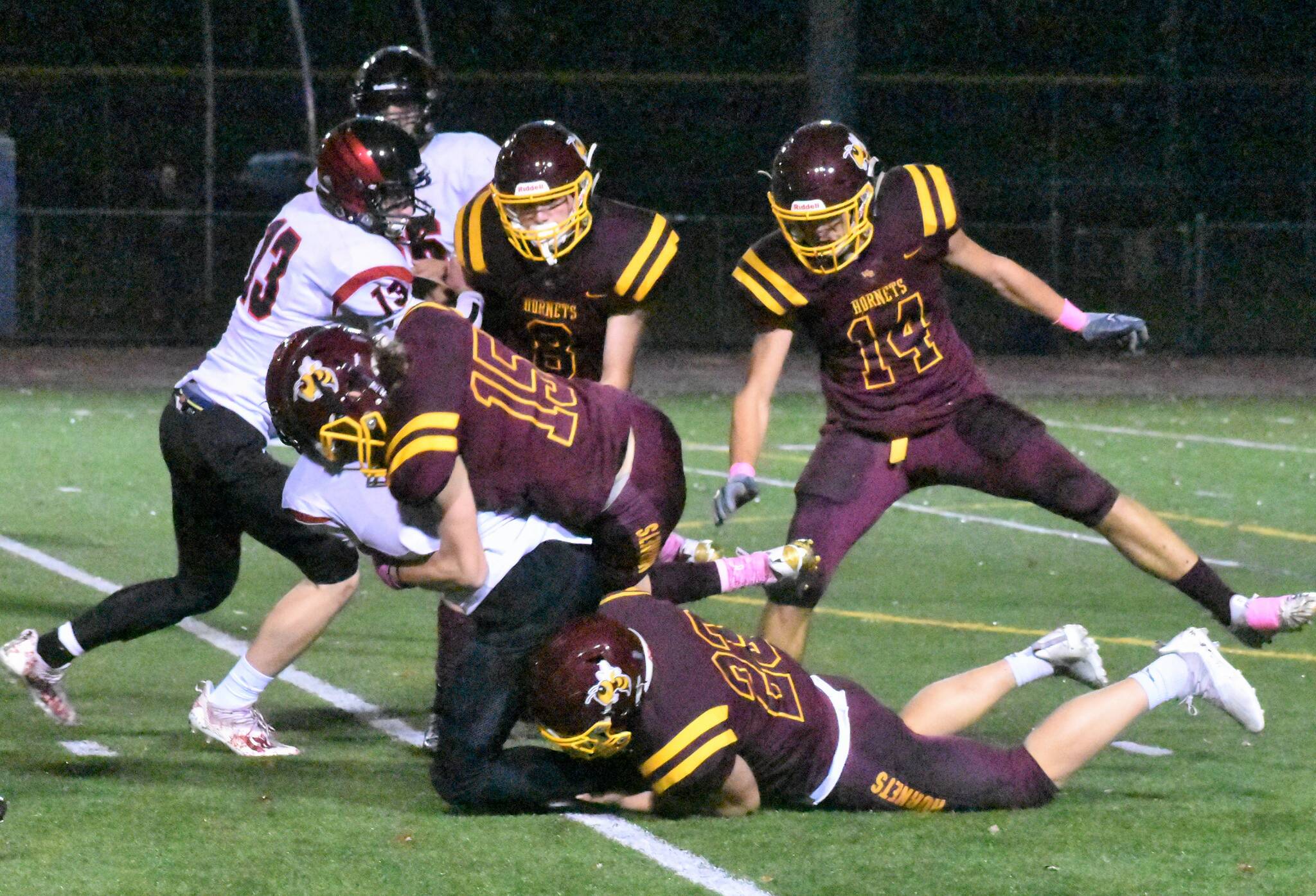 The White River defense stuffed the visiting Cardinals much of the night. Doing the honors here are Landon Mollett (15) and Logan Lisherness (23).