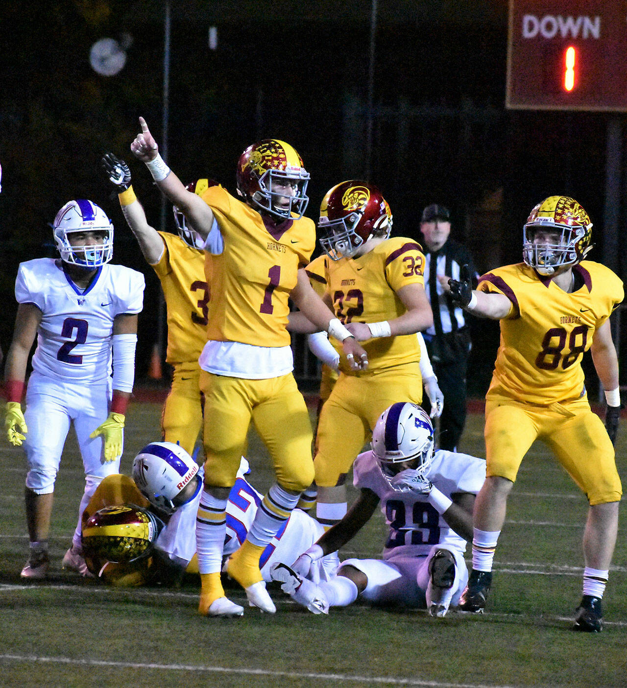 Enumclaw’s Clive Pond (1) and his Hornet teammates celebrate after recovering a Patriot fumble Friday night. Photo by Kevin Hanson