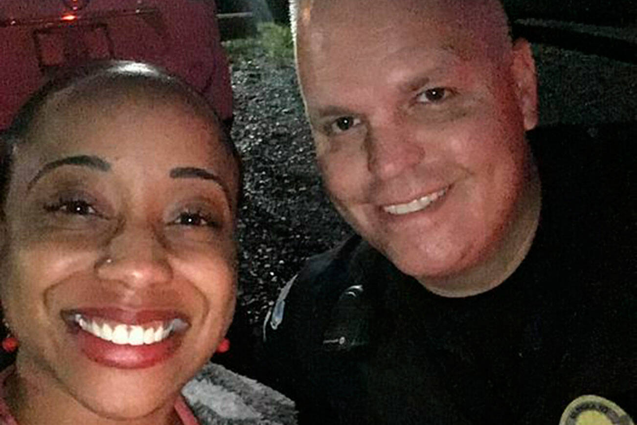 Sientje Morris and Black Diamond Sgt. Brian Lynch during a recent traffic stop where Lynch helped Morris get her car towed and repaired — all at no cost to her. Photo courtesy Black Diamond Police Department
