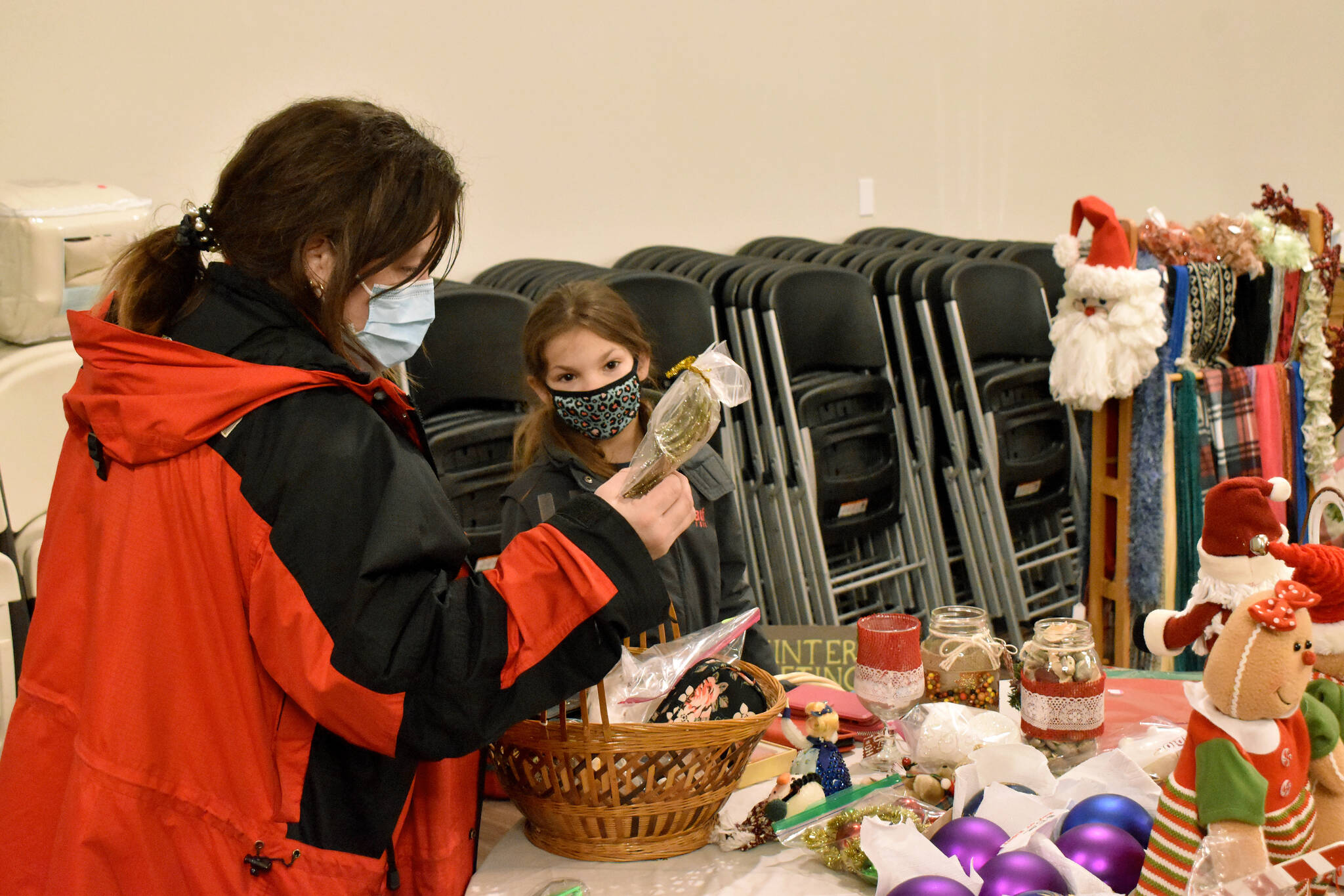 Photo by Alex Bruell
Andrea Tarling and her daughter Izzy, Buckley residents, look over items at the holiday bazaar.