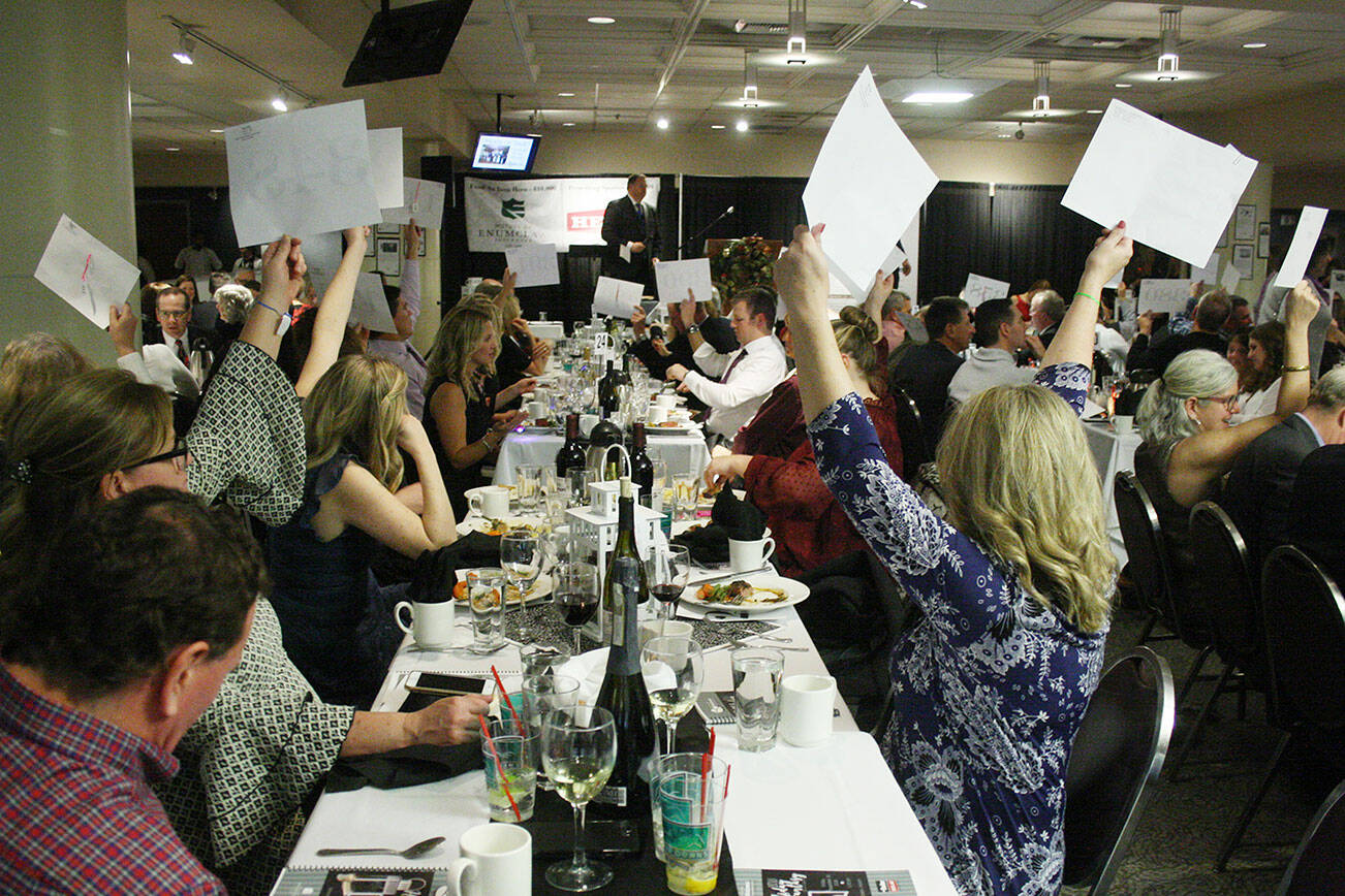 One of the highlights of Holiday Fantasy has been outright donations to a worthy cause. Here, attendees show their support during the 2018 event. This year, the event will be holding a virtual auction over four days while having the dinner at the Enumclaw Thunder Dome museum. Photo by Kevin Hanson
