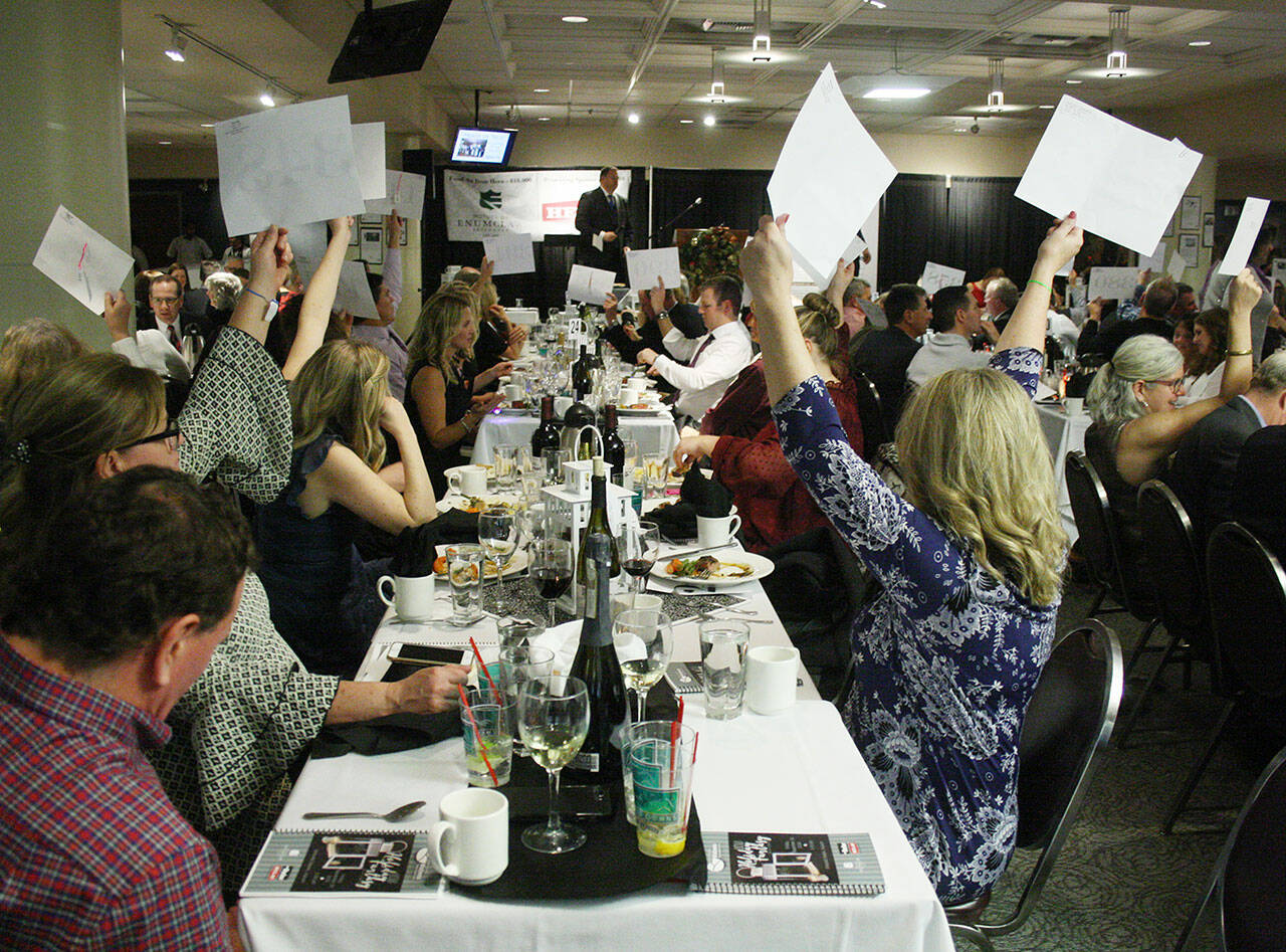 One of the highlights of Holiday Fantasy has been outright donations to a worthy cause. Here, attendees show their support during the 2018 event. This year, the event will be holding a virtual auction over four days. Photo by Kevin Hanson