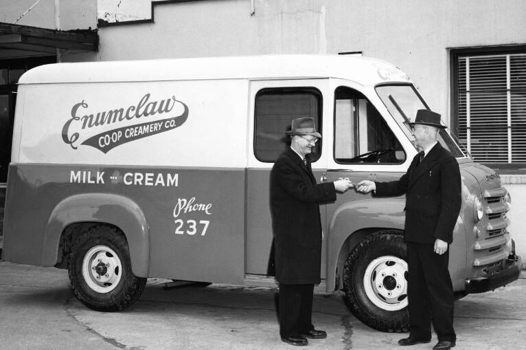 Photo courtesy King Country Library System 
Leonard Paulson (Paulson Motors) giving the keys of a new delivery truck to Enumclaw Co-op Creamery Co. manager J.K. Van Patten (estimated date 1940).
Leonard Paulson (Paulson Motors) giving the keys of a new delivery truck to Enumclaw Co-op Creamery Co. manager J.K. Van Patten (estimated date 1940). Photo courtesy Washington Rural Heritage archive
