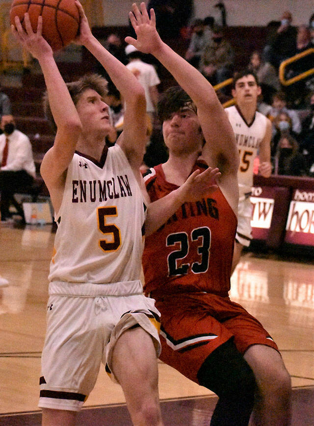 The Enumclaw High boys had little trouble picking up a league victory Dec. 15 when the Orting Cardinals visited Chuck Smith Gymnasium. In this photo, Liam Leonard (5) gets a shot off despite pressure from Orting’s Mason McCall. Photo by Kevin Hanson