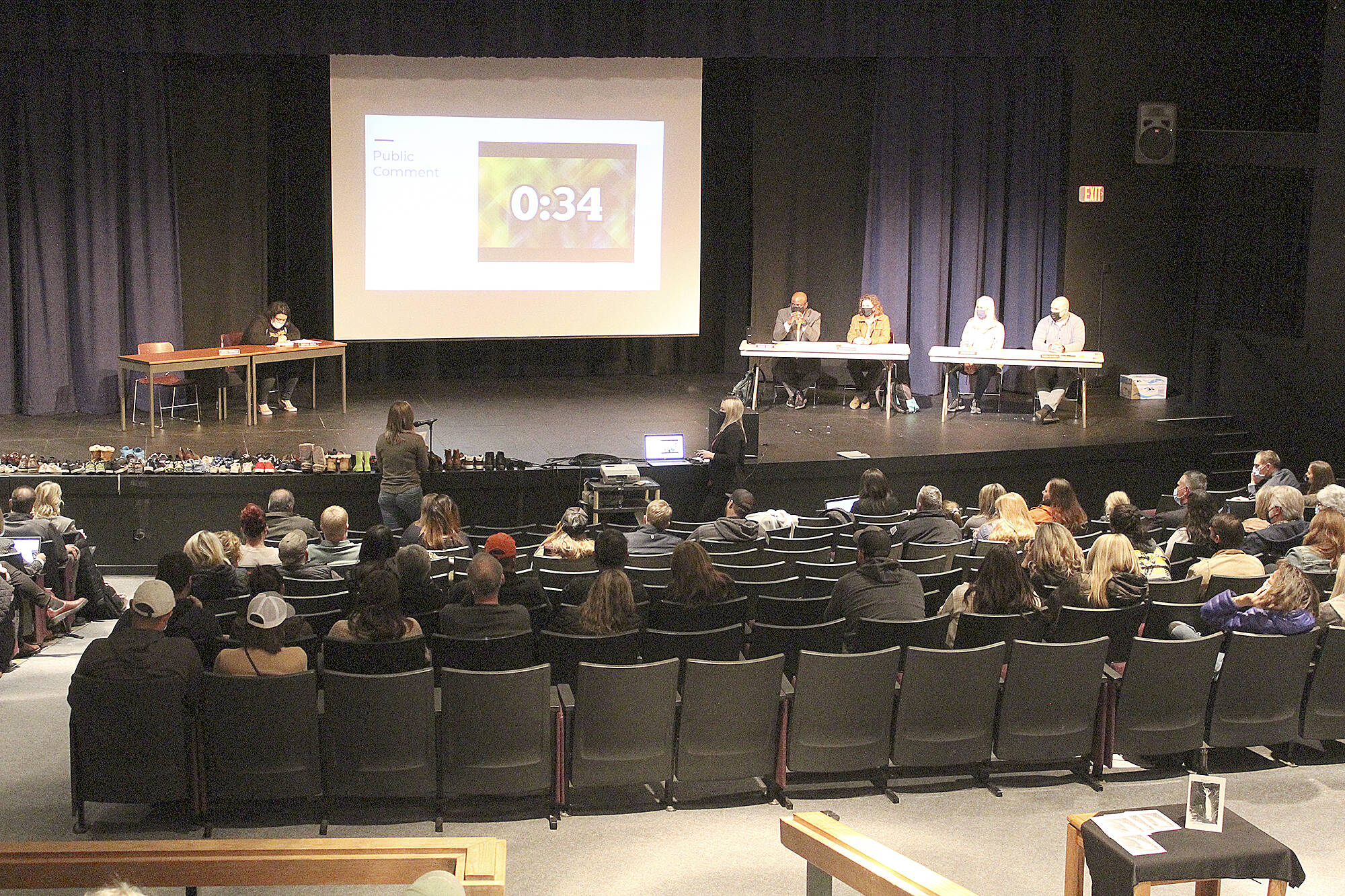 More than a dozen local residents — including students — spoke at the Nov. 22 Enumclaw School Board meeting, while audience members, filling up half the high school auditorium, showed their support for speakers with enthusiastic applause. Photo by Ray Miller-Still