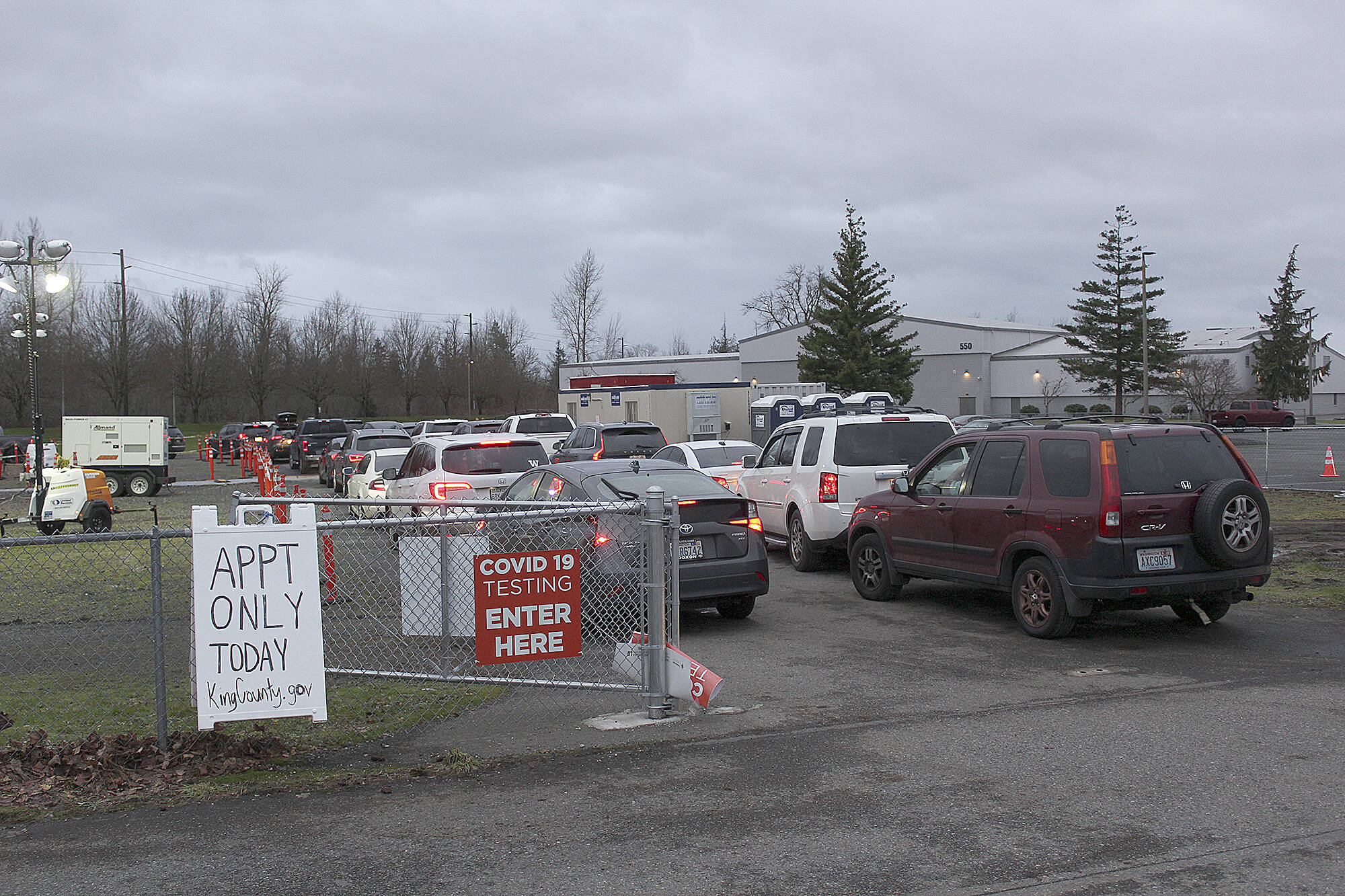 If you are looking to get a quick COVID test in Enumclaw, you may be out of luck — the testing site has recently been swamped with visitors (one Enumclaw police officer on scene said the line sometimes stretches from the tent at 550 Semanski Street S., down McDougall Ave., and onto 244th Ave. SE, roughly a half mile away), and "staffing challenges" at the site are further exacerbating wait times, King County has said. The test site now requires visitors to make an appointment online at www.solvhealth.com/book-online/pYWRj0 — however, as of Jan. 10, it appears there were virtually no appointments available through Jan. 14. The testing site is open Mondays, Tuesdays, Thursdays and Fridays from 9:30 a.m. to 7 p.m. 
In lieu of going to the testing site, you may be able to have a free COVID testing kit sent to your home, courtesy of the Greater Seattle Coronavirus Assessment Network. To enroll in the program, head to www.scanpublichealth.org/screener; kits typically arrive 24 hours after enrolling. The program warns it has a limited number of tests each day. 
Photos by Ray Miller-Still