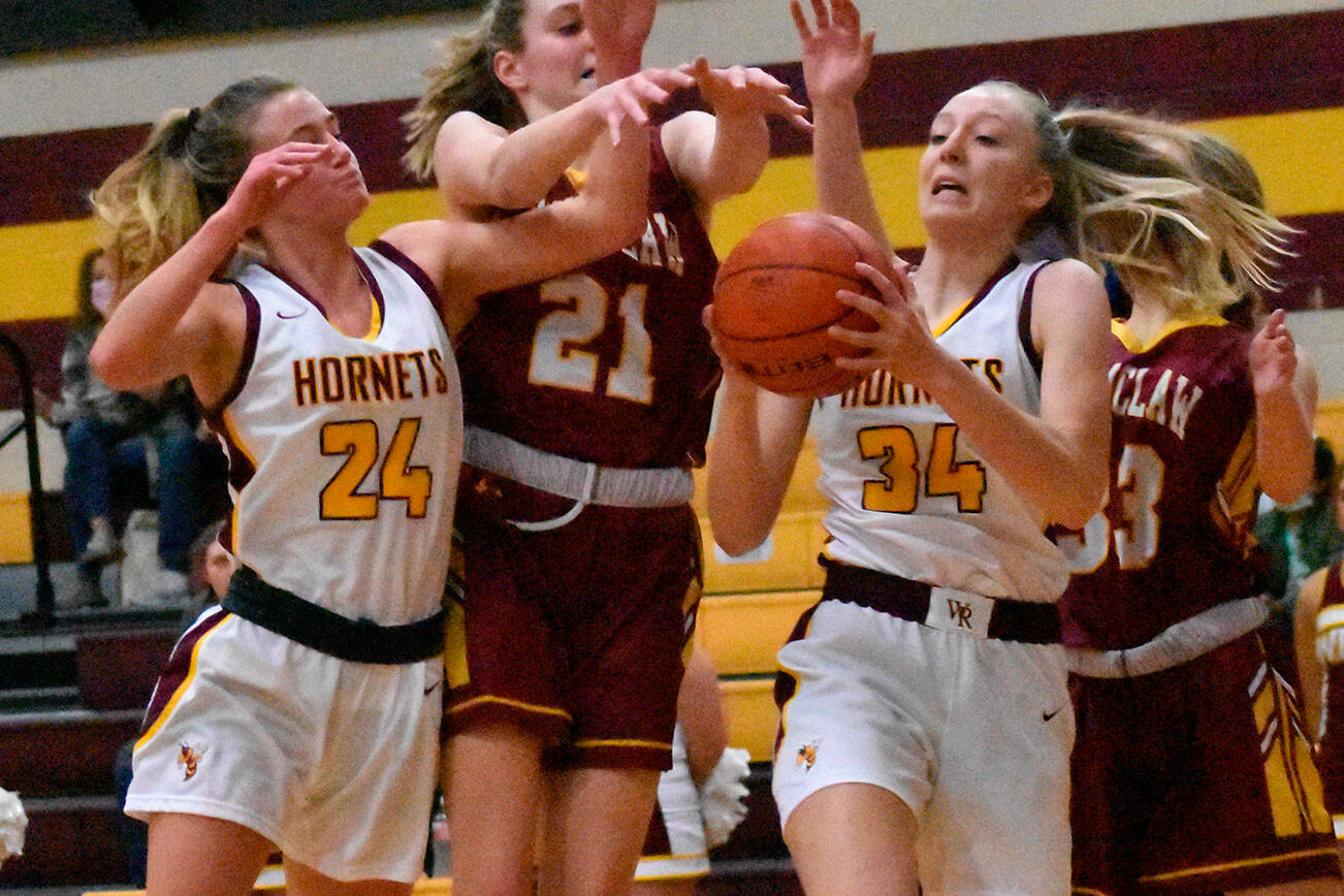 It was a Hornet-Hornet battle for a rebound Friday night when the girls' teams from White River and Enumclaw met in Buckley. Coming away with the ball is White River freshman Vivian Kingston; also in the scramble are teammate Josie Jacobs and Enumclaw's Bella Firnkoess (21). Photo by Kevin Hanson