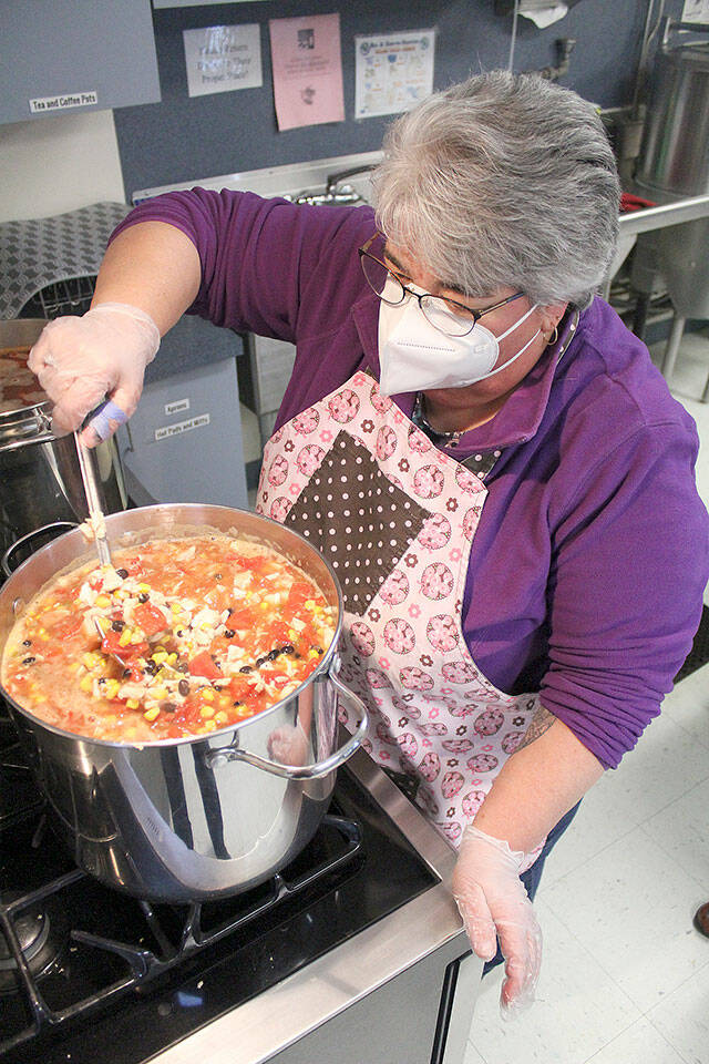 The Rainier Foothills Wellness Foundation continues to host its Full Bellies program at Calvary Presbyterian Church every Thursday from 5:30 to 6:30 p.m. Due to the ongoing pandemic, meals are prepared in advance to be picked up at the door. To volunteer, contact Colleen Michael at fullbellies@yahoo.com. Pictured Kathy Conzelman stirring the tortilla soup. Photo by Ray Miller-Still