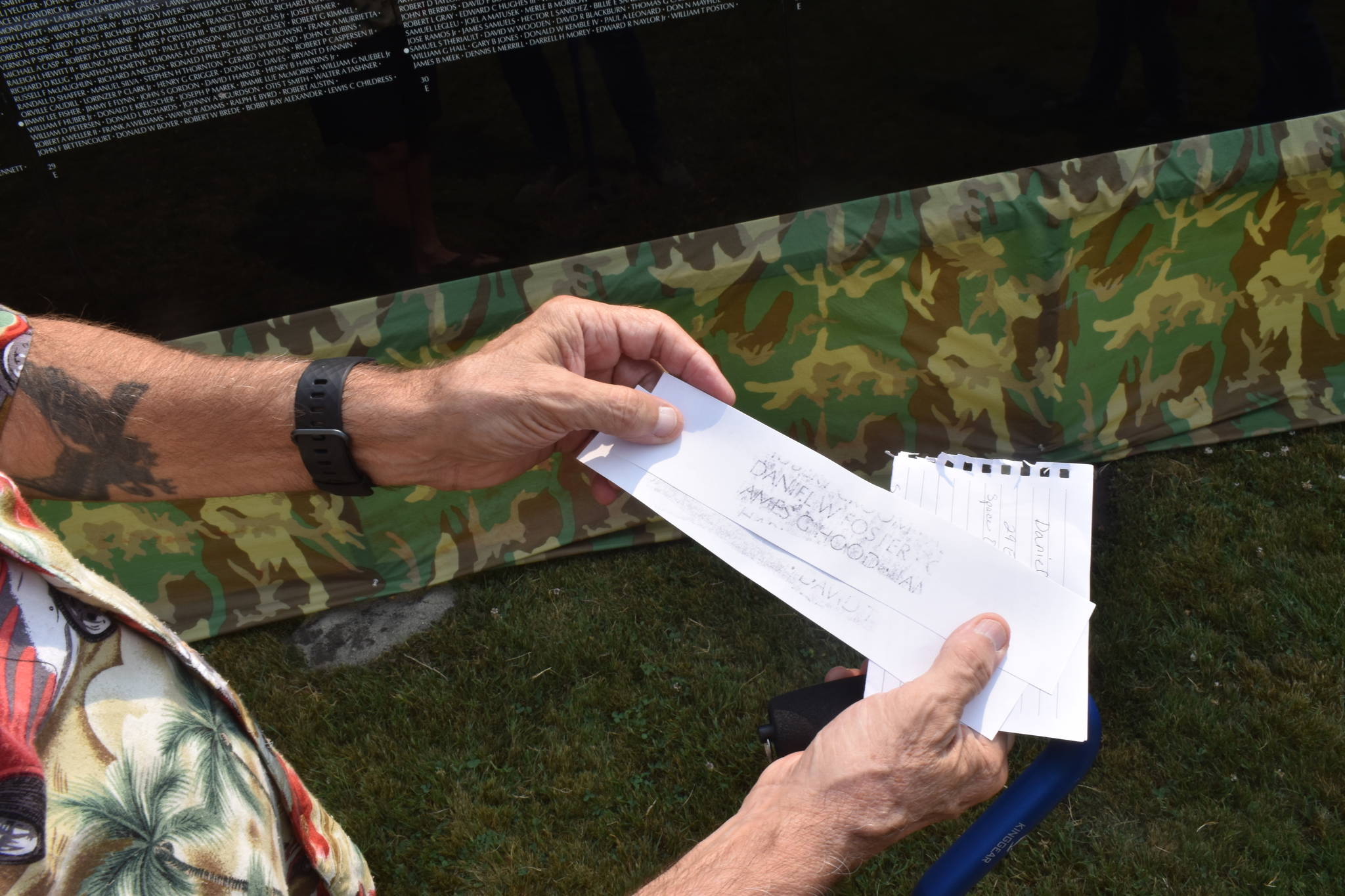 Bob Valentine holds a rubbing of the names of two people he knew who died in the Vietnam War.