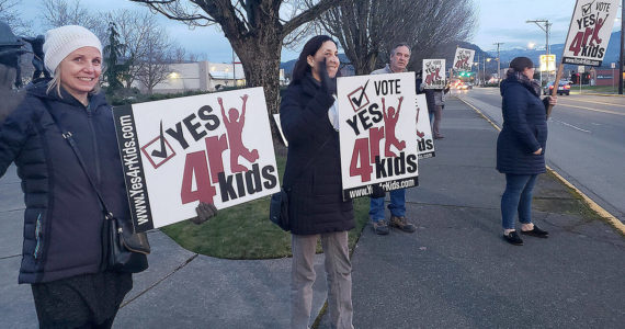 A small group on Griffin Avenue in Enumclaw supporting voting "Yes" on the local school district levy hours before ballots were due. Photo by Ray Miller-Still